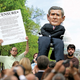 An activist holds aloft the censure motion so that all in the crowd can read it carefully and make up their minds.